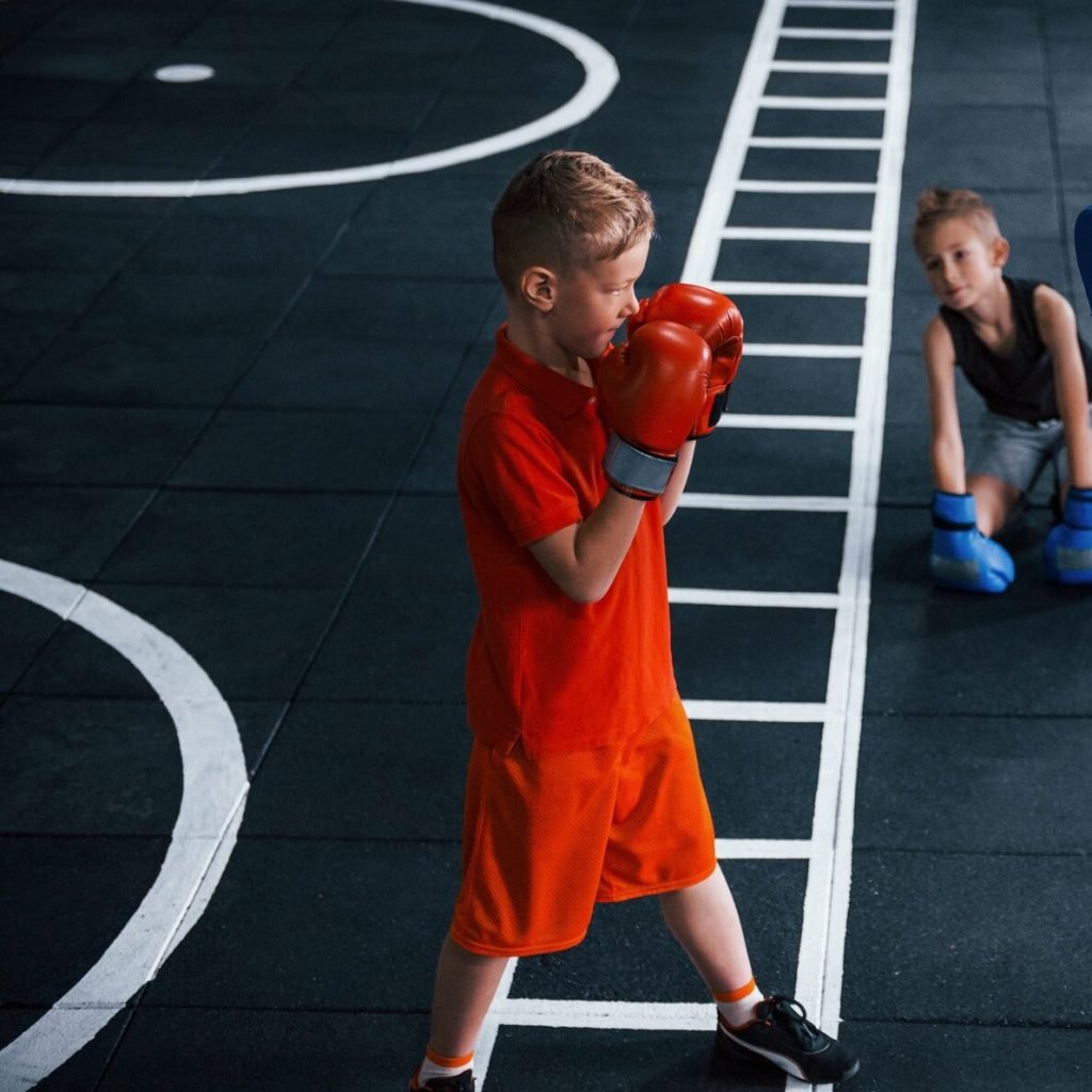 young-trainer-teaches-kids-boxing-sport-in-the-gym.jpg