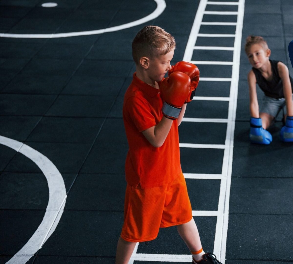 young-trainer-teaches-kids-boxing-sport-in-the-gym.jpg